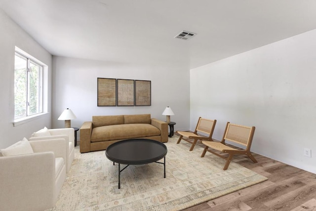 living room featuring wood finished floors and visible vents