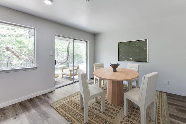 dining area featuring baseboards and wood finished floors