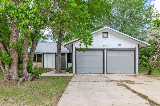 5912 Wagon Bnd, Austin, TX 78744 - mid-century home with a garage and a metal roof