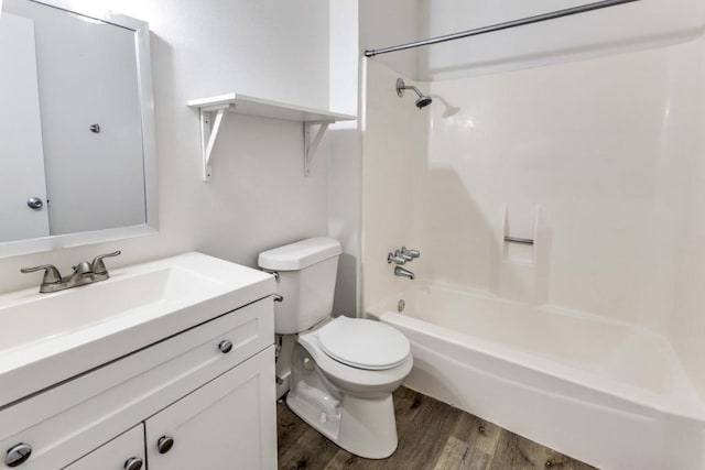 full bathroom with vanity, shower / tub combination, wood finished floors, and toilet