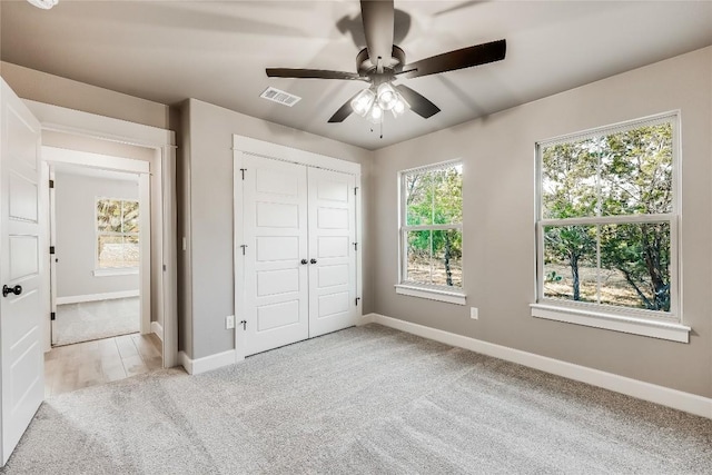 2502 Truman Dr, Lago Vista, TX 78645 - unfurnished bedroom featuring carpet flooring, ceiling fan, baseboards, visible vents, and a closet