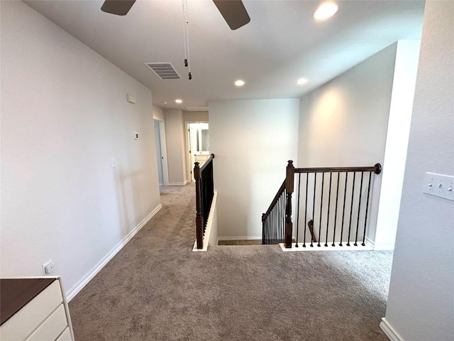 corridor with visible vents, baseboards, recessed lighting, carpet flooring, and an upstairs landing