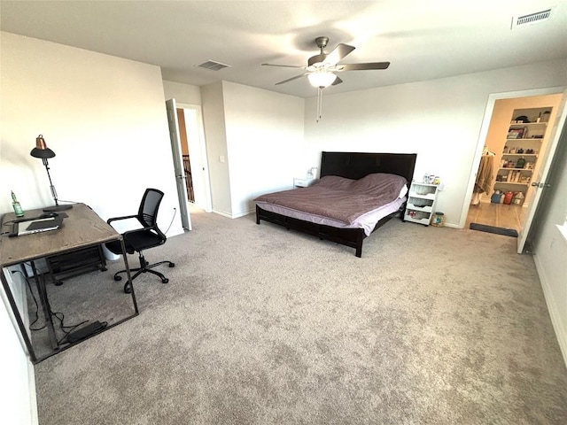 carpeted bedroom featuring baseboards, a ceiling fan, and visible vents