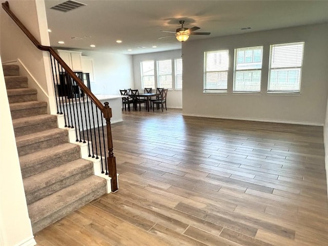 interior space with visible vents, wood finished floors, baseboards, recessed lighting, and a ceiling fan