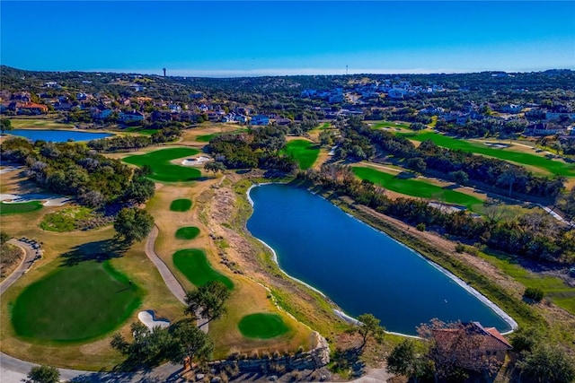 drone / aerial view featuring a residential view, a water view, and golf course view