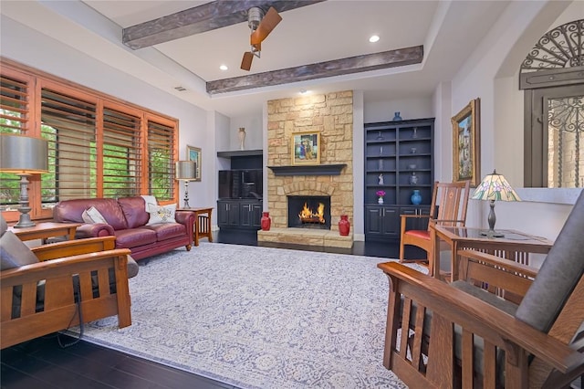 living room featuring beam ceiling, wood finished floors, a fireplace, recessed lighting, and a ceiling fan