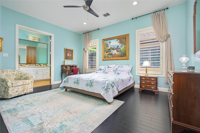 bedroom featuring visible vents, baseboards, dark wood-style floors, recessed lighting, and connected bathroom