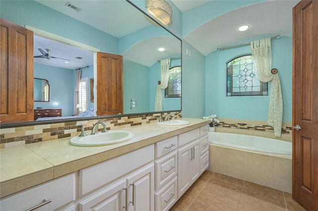 full bathroom with visible vents, a wealth of natural light, a sink, and a bath