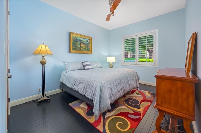 bedroom with a ceiling fan, baseboards, and dark wood finished floors