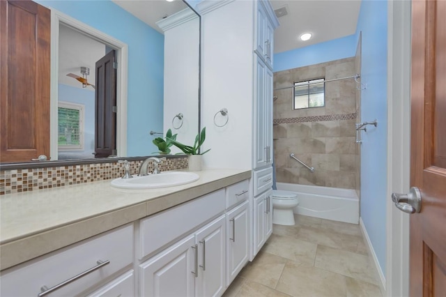 full bath featuring vanity, tile patterned flooring, toilet, baseboards, and shower / bath combination