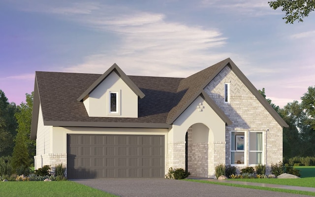view of front of house with driveway, a shingled roof, stone siding, and stucco siding