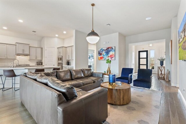 216 Vista Village Cv, Austin, TX 78738 - living area featuring light wood-style floors, recessed lighting, and baseboards