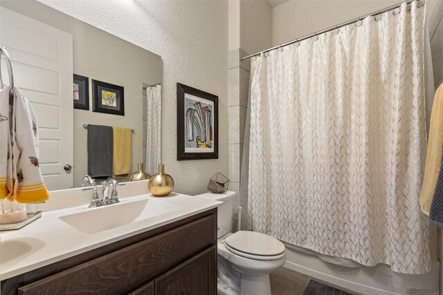 216 Vista Village Cv, Austin, TX 78738 - bathroom with vanity, toilet, shower / bathtub combination with curtain, and a textured wall