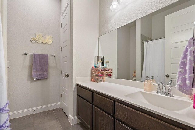 216 Vista Village Cv, Austin, TX 78738 - bathroom featuring tile patterned floors, vanity, baseboards, and a shower with curtain
