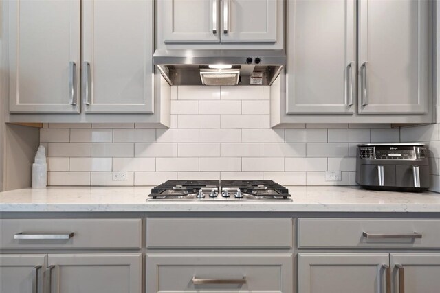 216 Vista Village Cv, Austin, TX 78738 - kitchen with wall chimney exhaust hood and gray cabinets