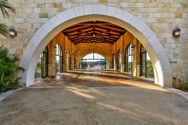 216 Vista Village Cv, Austin, TX 78738 - doorway to property featuring concrete driveway and stone siding