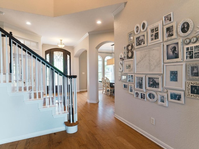 19200 White Horse Cv, Spicewood, TX 78669 - foyer entrance with crown molding, arched walkways, baseboards, and stairs