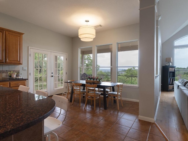 19200 White Horse Cv, Spicewood, TX 78669 - dining room featuring baseboards, a wealth of natural light, and french doors