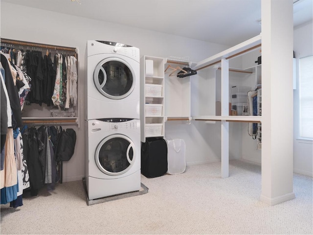 19200 White Horse Cv, Spicewood, TX 78669 - laundry room with laundry area, carpet, stacked washing maching and dryer, and baseboards