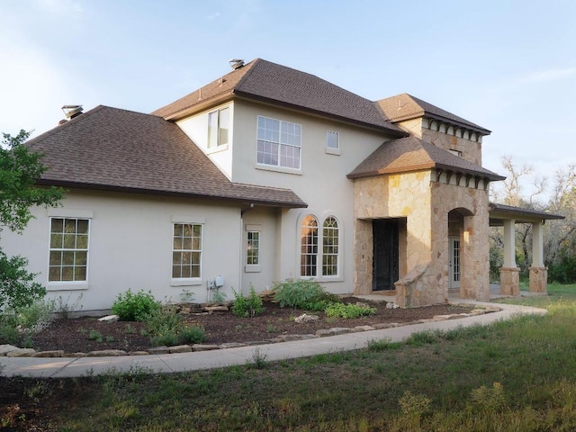 19200 White Horse Cv, Spicewood, TX 78669 - back of property featuring roof with shingles, stucco siding, and stone siding