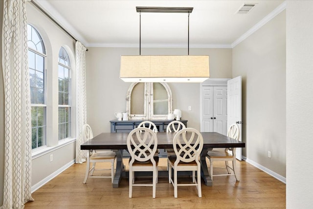 19200 White Horse Cv, Spicewood, TX 78669 - dining area featuring ornamental molding and light wood-style flooring