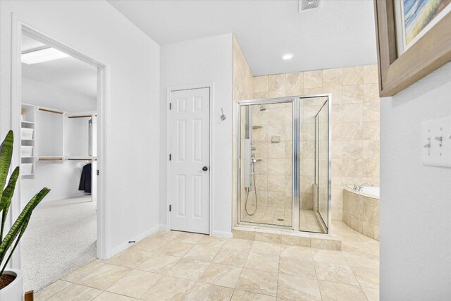 19200 White Horse Cv, Spicewood, TX 78669 - full bathroom featuring a stall shower, a bath, and a closet