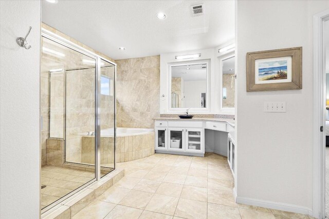 19200 White Horse Cv, Spicewood, TX 78669 - bathroom featuring a shower stall, vanity, a garden tub, tile patterned floors, and recessed lighting