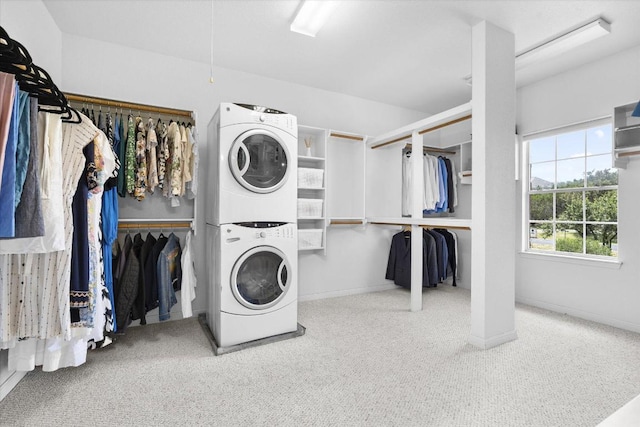 19200 White Horse Cv, Spicewood, TX 78669 - laundry room featuring stacked washing machine and dryer, carpet flooring, and attic access