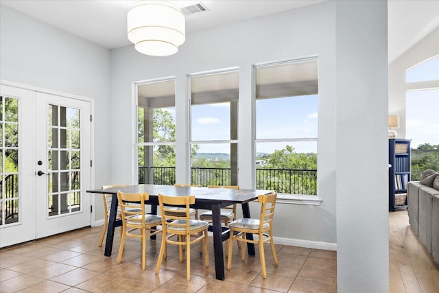 19200 White Horse Cv, Spicewood, TX 78669 - tiled dining space featuring baseboards and french doors