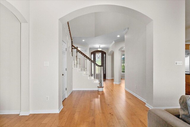 19200 White Horse Cv, Spicewood, TX 78669 - entrance foyer with arched walkways, light wood-style floors, stairs, and recessed lighting