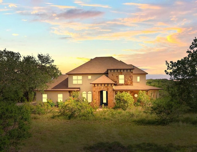 19200 White Horse Cv, Spicewood, TX 78669 - view of front of property featuring stone siding, roof with shingles, and stucco siding