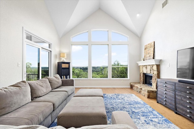 19200 White Horse Cv, Spicewood, TX 78669 - living room featuring vaulted ceiling and a fireplace