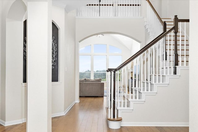 19200 White Horse Cv, Spicewood, TX 78669 - foyer with wood-type flooring, stairway, and arched walkways