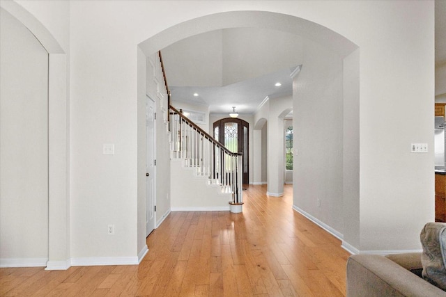 19200 White Horse Cv, Spicewood, TX 78669 - entrance foyer featuring arched walkways, light wood-style floors, stairs, and recessed lighting