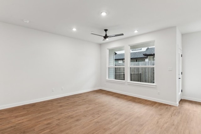 unfurnished room with baseboards, a ceiling fan, wood finished floors, and recessed lighting