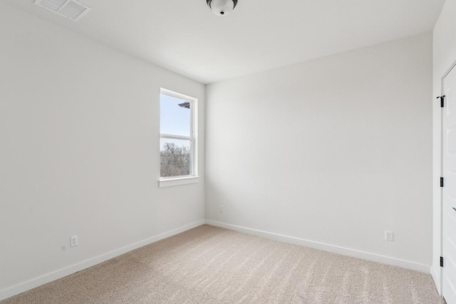 unfurnished room featuring visible vents, baseboards, and light colored carpet