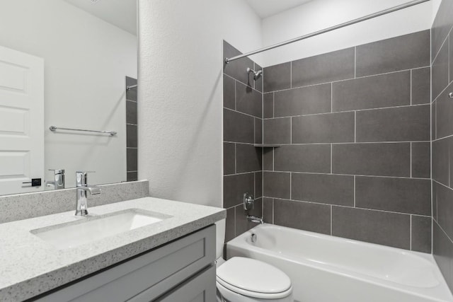 bathroom featuring toilet, tub / shower combination, and vanity