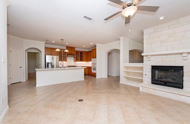 411 Brazos Dr, Georgetown, TX 78628 - unfurnished living room with light tile patterned flooring, ornamental molding, a sink, recessed lighting, and a ceiling fan