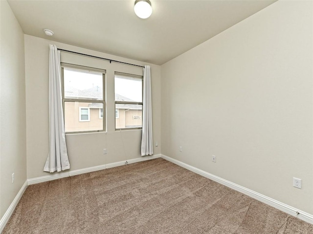 carpeted empty room with baseboards