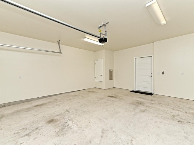 garage featuring a garage door opener and electric panel