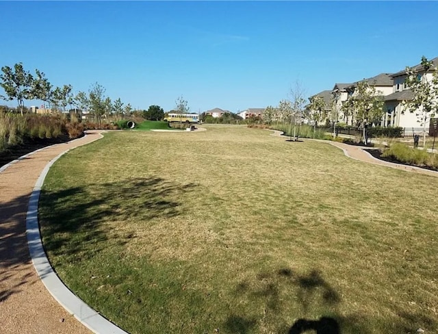 view of property's community with a residential view and a lawn
