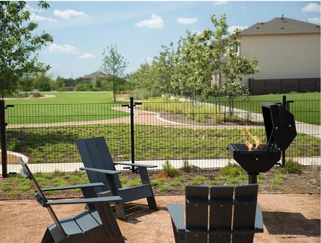 view of home's community featuring a yard and fence