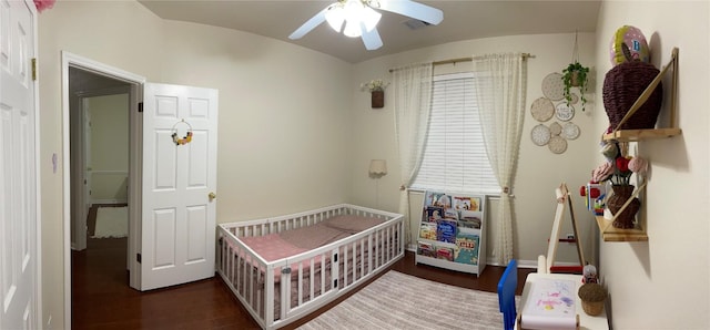 2305 Amen Corner Rd, Pflugerville, TX 78660 - bedroom featuring a crib, a ceiling fan, and wood finished floors