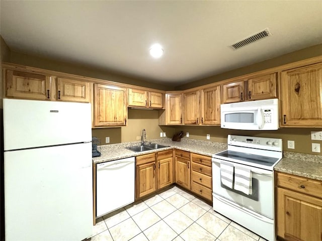kitchen featuring visible vents, a sink, light tile patterned floors, light countertops, and white appliances
