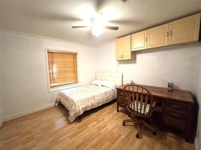 bedroom featuring a ceiling fan, baseboards, and light wood-style floors