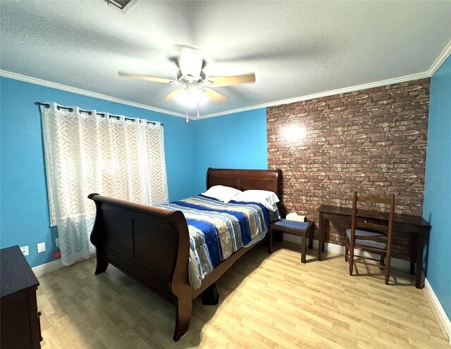 bedroom with crown molding, a textured ceiling, baseboards, and wood finished floors