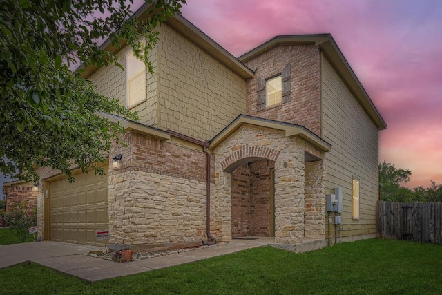 9504 Southwick Dr, Austin, TX 78724 - view of front of property featuring a garage, stone siding, and driveway