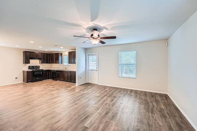 9504 Southwick Dr, Austin, TX 78724 - unfurnished living room featuring a sink, light wood-type flooring, ceiling fan, baseboards, and recessed lighting