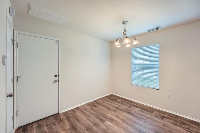 9504 Southwick Dr, Austin, TX 78724 - empty room featuring wood finished floors, a chandelier, and baseboards