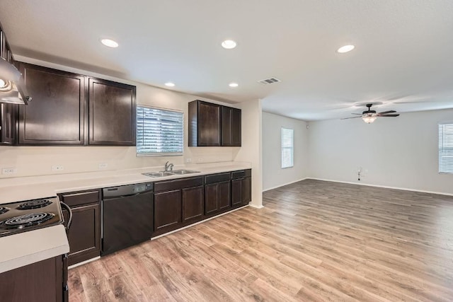9504 Southwick Dr, Austin, TX 78724 - kitchen featuring black dishwasher, a sink, dark brown cabinetry, light countertops, and light wood-style floors